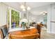 Bright dining area features sliding glass doors, wood table and seating for four at 1817 Heisser Ln, Fuquay Varina, NC 27526