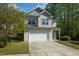 Two-story home with neutral siding, a two-car garage, and a well-maintained lawn at 1817 Heisser Ln, Fuquay Varina, NC 27526