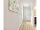Hallway with wood floors leading to bathroom and a white paneled door at 1817 Heisser Ln, Fuquay Varina, NC 27526