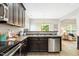 Open kitchen features stainless steel dishwasher, dark cabinets, and laminate counters at 1817 Heisser Ln, Fuquay Varina, NC 27526