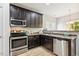 Well-equipped kitchen features stainless steel appliances, dark cabinets, and laminate counters at 1817 Heisser Ln, Fuquay Varina, NC 27526
