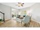 Open concept living room with wood floors, comfortable seating, and view into the dining area at 1817 Heisser Ln, Fuquay Varina, NC 27526