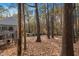 A backyard with a house and a deck surrounded by trees and foliage at 19 Lansgate Ct, Durham, NC 27713