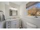 Bright bathroom featuring a white vanity with marble countertop and decorative mirror at 19 Lansgate Ct, Durham, NC 27713