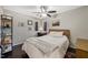Inviting bedroom with a ceiling fan, natural light from multiple windows, and neutral decor at 19 Lansgate Ct, Durham, NC 27713