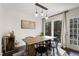 Bright dining room with modern lighting, a wooden table, black chairs, and a sliding glass door leading outdoors at 19 Lansgate Ct, Durham, NC 27713