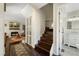 Hallway view with stairs, closet, and partial views of the living room and bathroom at 19 Lansgate Ct, Durham, NC 27713