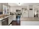 Bright kitchen with granite countertops, white cabinets, stainless steel appliances, and dark hardwood floors at 19 Lansgate Ct, Durham, NC 27713