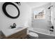 Bright bathroom with a modern vanity, tub/shower combo, and updated fixtures at 203 W Pilot St, Durham, NC 27707