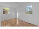 Bright bedroom featuring wood-look flooring and natural light from two windows at 203 W Pilot St, Durham, NC 27707