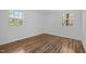 Light filled bedroom featuring two windows and wood-look flooring at 203 W Pilot St, Durham, NC 27707
