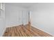 Spacious bedroom with wood-look flooring and a view to another room at 203 W Pilot St, Durham, NC 27707