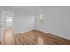 Bright bedroom featuring laminate floors, a window, and neutral white walls at 203 W Pilot St, Durham, NC 27707