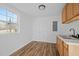 Bright kitchenette with window, cabinet, door, and plank flooring at 203 W Pilot St, Durham, NC 27707