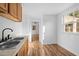 Bright kitchenette with a stainless steel sink and wood-look flooring at 203 W Pilot St, Durham, NC 27707