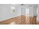 Bright living room with laminate flooring, white walls, and multiple doorways at 203 W Pilot St, Durham, NC 27707