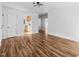 Open-concept living area with laminate flooring, white walls, and multiple doorways at 203 W Pilot St, Durham, NC 27707