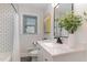 Bright bathroom with subway tile, modern fixtures, and a marble vanity at 206 Bickett Blvd, Raleigh, NC 27608