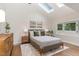 Serene bedroom featuring skylights, a neutral color palette, and hardwood floors at 206 Bickett Blvd, Raleigh, NC 27608
