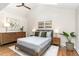 Vaulted ceiling bedroom with a ceiling fan and natural light, featuring neutral décor and hardwood floors at 206 Bickett Blvd, Raleigh, NC 27608