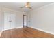 Empty bedroom with hardwood floors, closet, and a ceiling fan at 206 Bickett Blvd, Raleigh, NC 27608