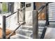 Front entryway features steps, a modern railing, and a painted brick facade for a welcoming entrance at 206 Bickett Blvd, Raleigh, NC 27608