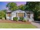 Charming home showcasing a well-maintained lawn and freshly mulched landscaping at 206 Bickett Blvd, Raleigh, NC 27608