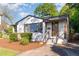 Charming brick home with a well-manicured lawn, black shutters and painted brickwork providing timeless curb appeal at 206 Bickett Blvd, Raleigh, NC 27608