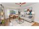 Airy living room with stylish furnishings, a ceiling fan, and a large window with a view at 206 Bickett Blvd, Raleigh, NC 27608