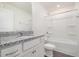 Elegant bathroom featuring granite counters, white cabinets, and a tub-shower combo for relaxation at 210 Silas St, Durham, NC 27705