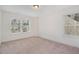 Bright bedroom with neutral walls, plush carpet, and two windows with natural light at 210 Silas St, Durham, NC 27705