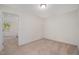 Cozy bedroom with neutral carpet and a view through the open doorway to another room at 210 Silas St, Durham, NC 27705