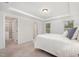 Comfortable bedroom features a walk-in closet, tray ceiling, and bright windows for lots of natural light at 210 Silas St, Durham, NC 27705