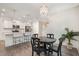 Charming dining area with modern lighting, open to a kitchen with bar seating and stainless appliances at 210 Silas St, Durham, NC 27705