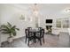 Dining area featuring a round table, stylish chairs, and a modern chandelier, with natural light streaming in at 210 Silas St, Durham, NC 27705
