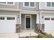 Charming front entrance of a home with stone accents, a covered porch, and a well-maintained exterior at 210 Silas St, Durham, NC 27705