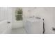 Functional laundry room with a washer, dryer, and a window for natural light at 210 Silas St, Durham, NC 27705