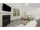 Bright living room featuring a fireplace, large windows, and neutral decor for a cozy atmosphere at 210 Silas St, Durham, NC 27705