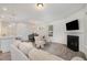 Spacious living area showcasing a fireplace, adjacent kitchen and dining space, filled with natural light at 210 Silas St, Durham, NC 27705