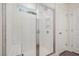 Modern bathroom shower with white tile, glass door, rainfall shower head, and convenient built-in niche at 210 Silas St, Durham, NC 27705