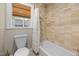 Bathroom featuring a shower, tiled floors, and a window with a wood blind at 211 Hargrove St St, Durham, NC 27701