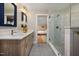 Bathroom with a double vanity, glass shower, with a glimpse of the bedroom at 211 Hargrove St St, Durham, NC 27701