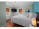 Comfortable bedroom with wood floors, a cozy bed, and windows with wood blinds at 211 Hargrove St St, Durham, NC 27701