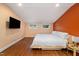 Comfortable bedroom with hardwood floors, natural light, and a built-in TV at 211 Hargrove St St, Durham, NC 27701