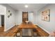 Dining room featuring a long wooden table, bench seating, and a sliding barn door at 211 Hargrove St St, Durham, NC 27701