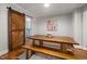 Dining room with a long wooden table, bench seating, and a rustic barn door at 211 Hargrove St St, Durham, NC 27701