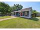 Blue home featuring a welcoming covered front porch, lush lawn and vibrant red front door at 211 Hargrove St St, Durham, NC 27701