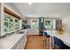 Bright kitchen featuring stainless steel appliances, wood floors, a central island, and a window at 211 Hargrove St St, Durham, NC 27701