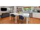 Kitchen island with white marble countertop and blue chairs; open to the living area at 211 Hargrove St St, Durham, NC 27701