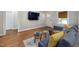 Open-concept living room with hardwood floors and a comfortable gray sectional sofa at 211 Hargrove St St, Durham, NC 27701